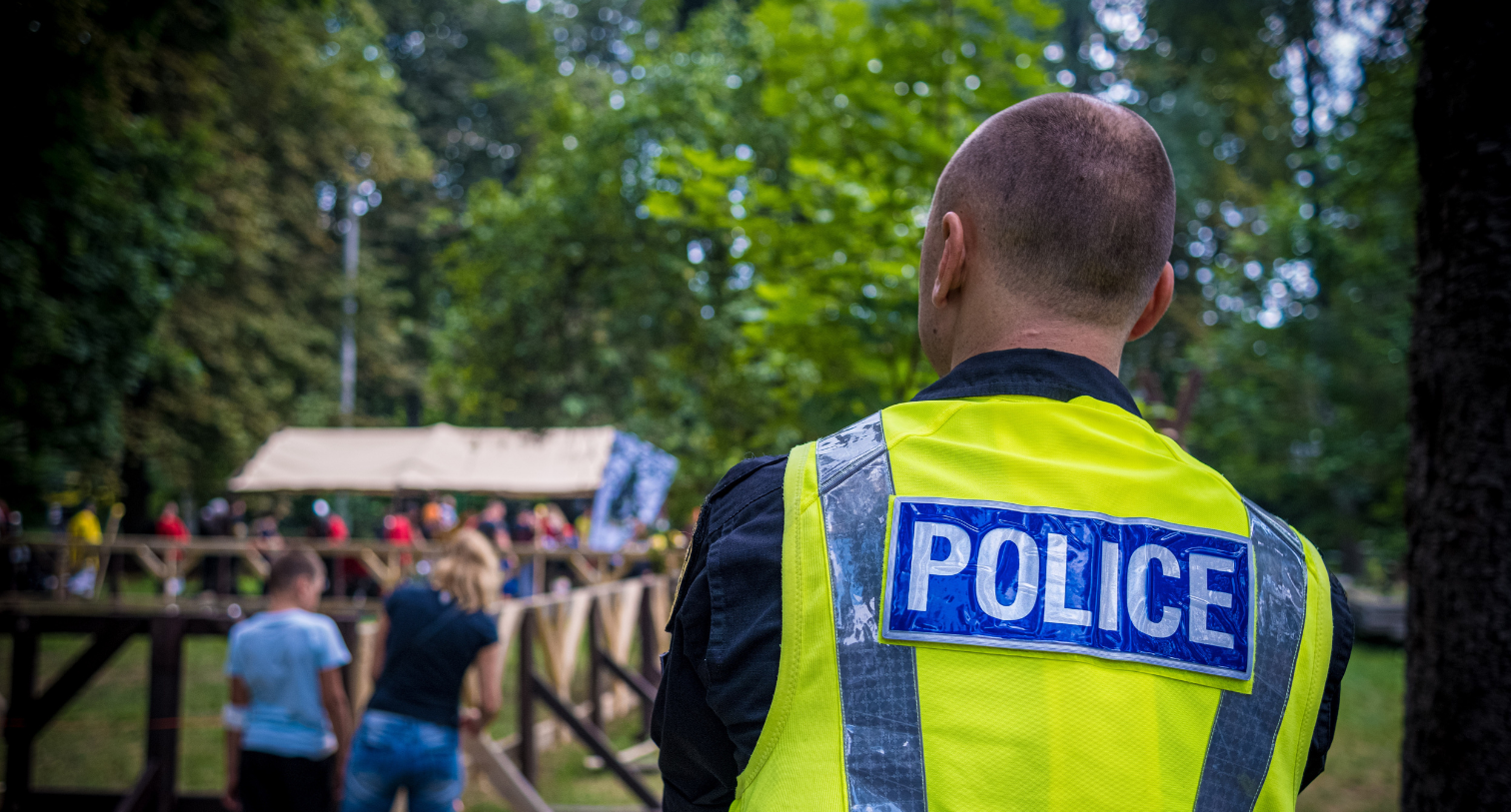 UK Police Officer watching a group of people